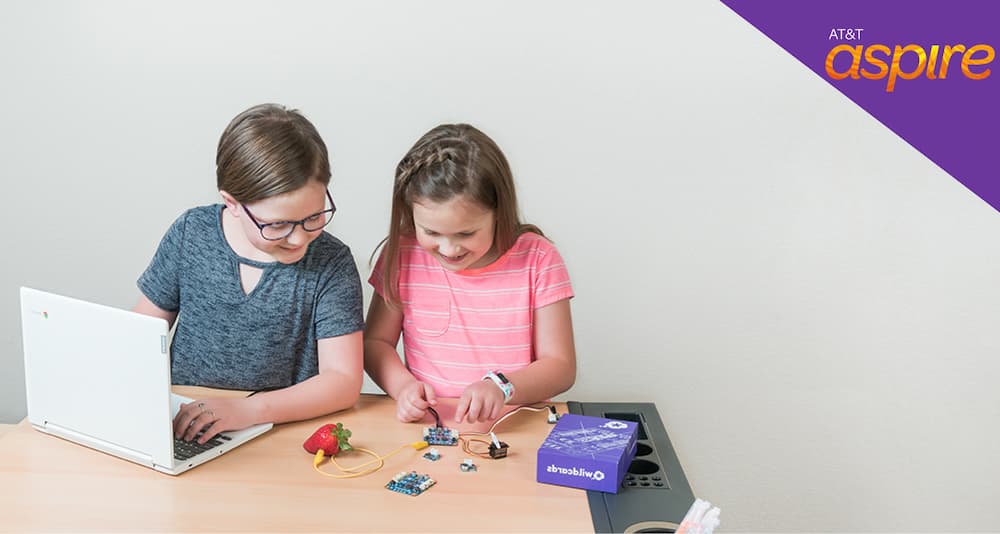Girl in glasses making STEM projects with circuit cards